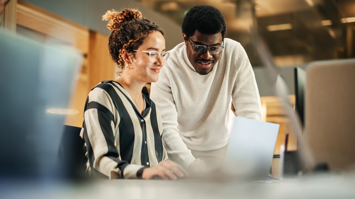 A man and woman enjoying Wi-Fi on a laptop