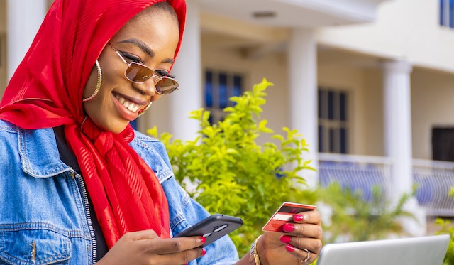 Women happily looking at her credit card