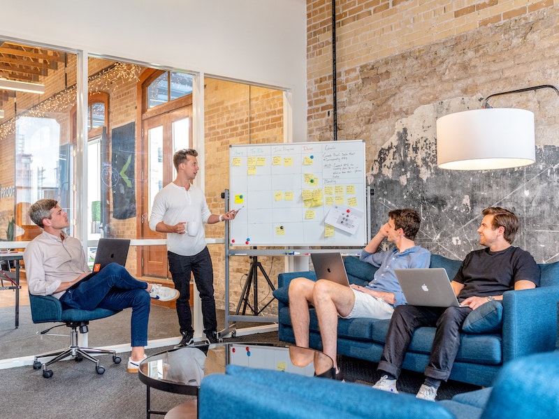 Four men in a hybrid workspace