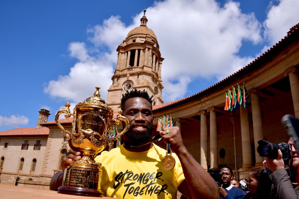 Springbok captain Siya Kolisi at the Union Buildings holding up his medal and trophy