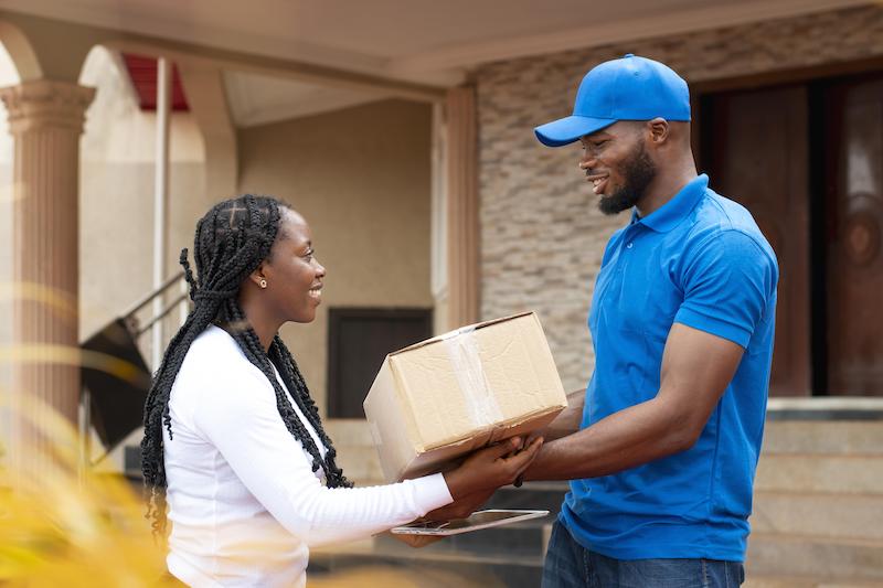 close-up-delivery-person-giving-parcel-client