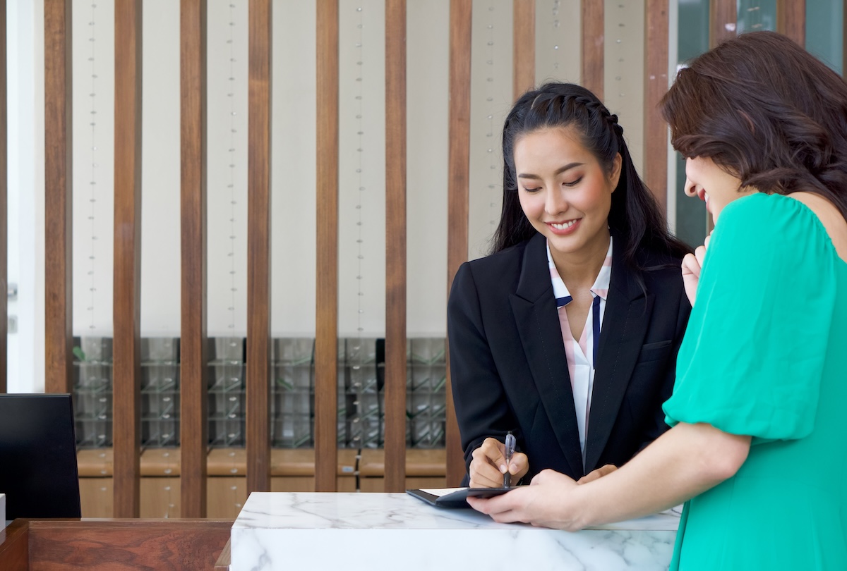 Hotel receptionist helping a guest check-in