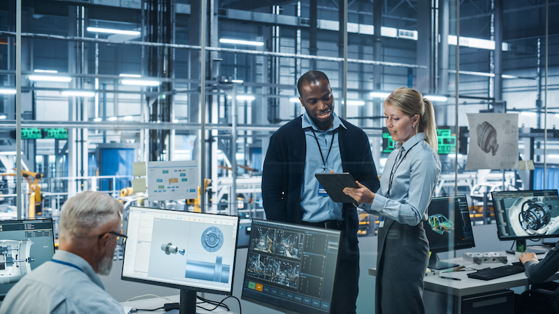 3 engineers looking at devices